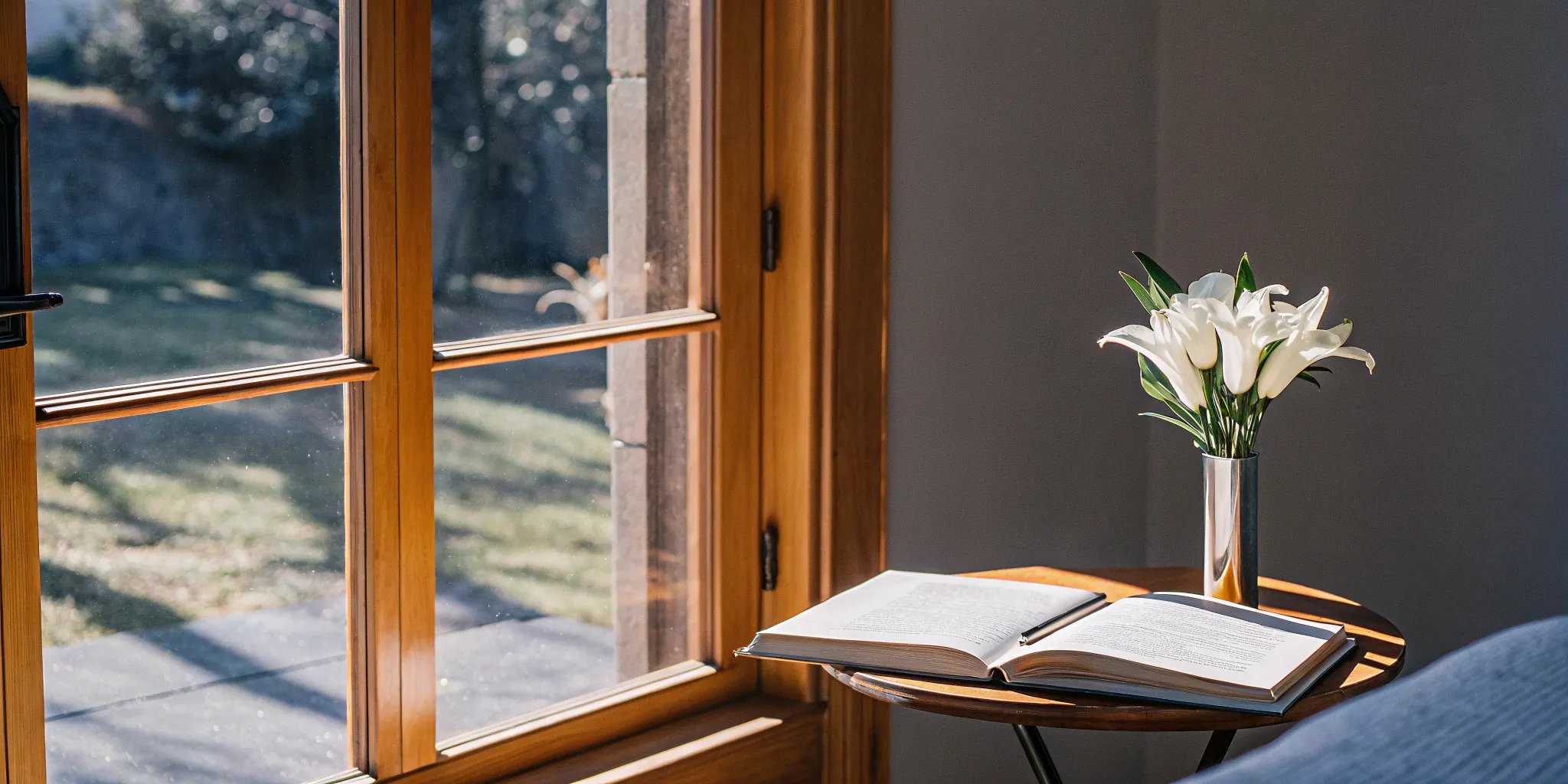 Wedding officiant's open book, lilies, and sunny window.