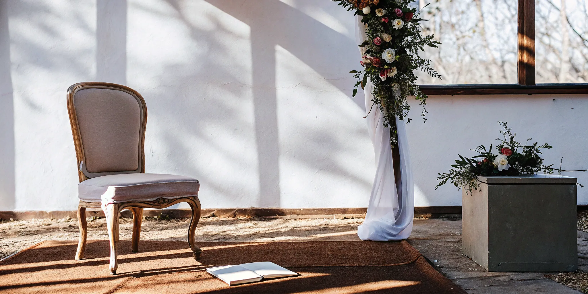 Wedding officiant's notebook and flowers in a sunlit ceremony setting.