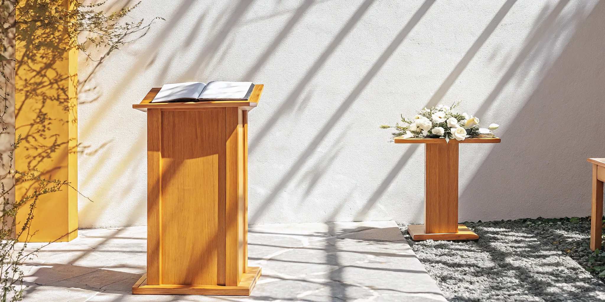 Wedding officiant's podium with open book and flowers.