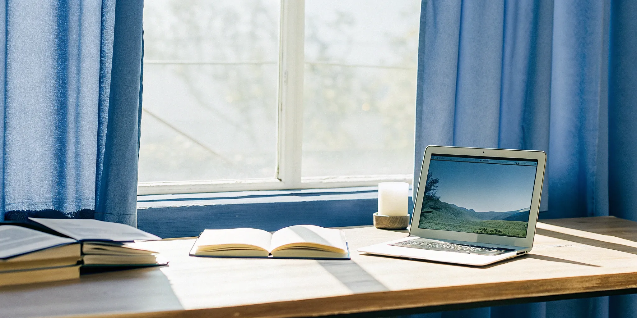 Laptop and books on a desk for researching the best online ministry ordination.